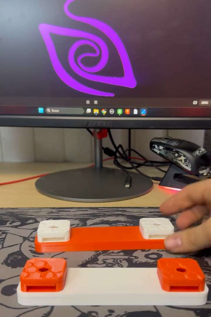 Soportes naranja y blanco para cámaras Raspberry Pi, frente al logo de Pro-In en un monitor